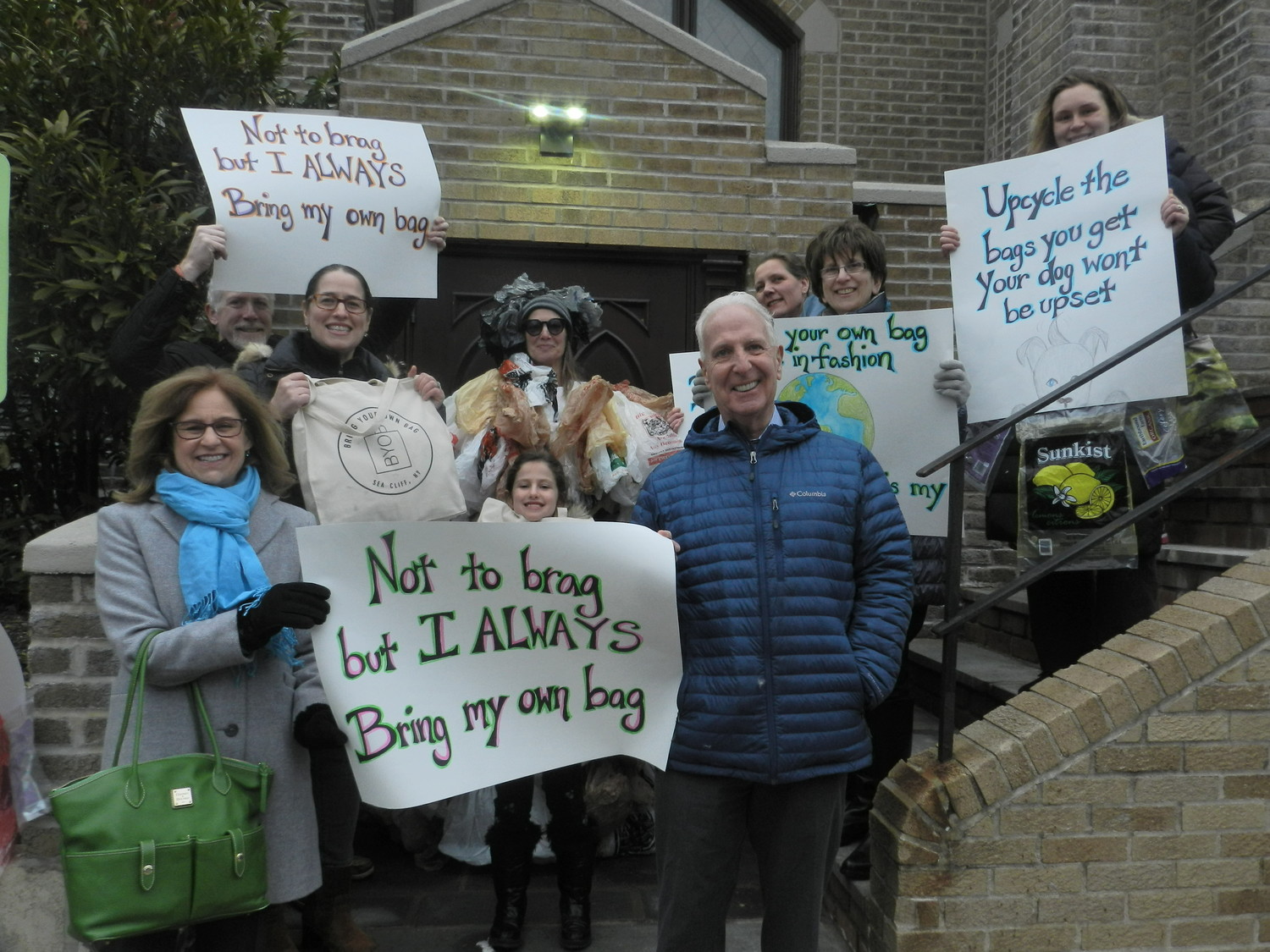 Trustees Dina Epstein, far left, and Kevin McGilloway joined residents in support of a “bring your own bag” ordinance for the village.