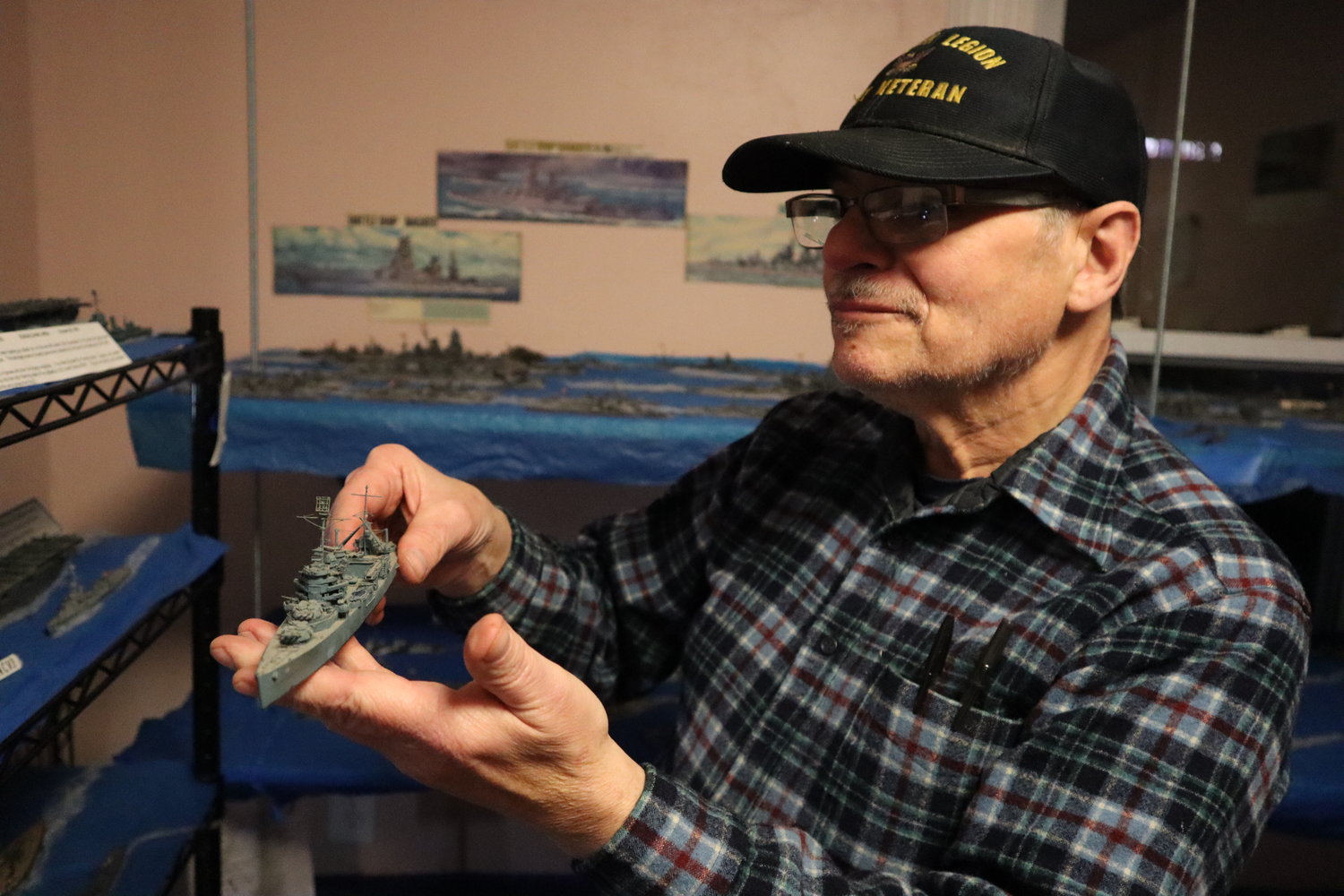 Navy Veteran George Wells shows the detail that went into building each model ship.